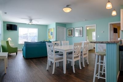 Living area with TV & dining table in Madison House at South Beach Apartments in Ocean City MD