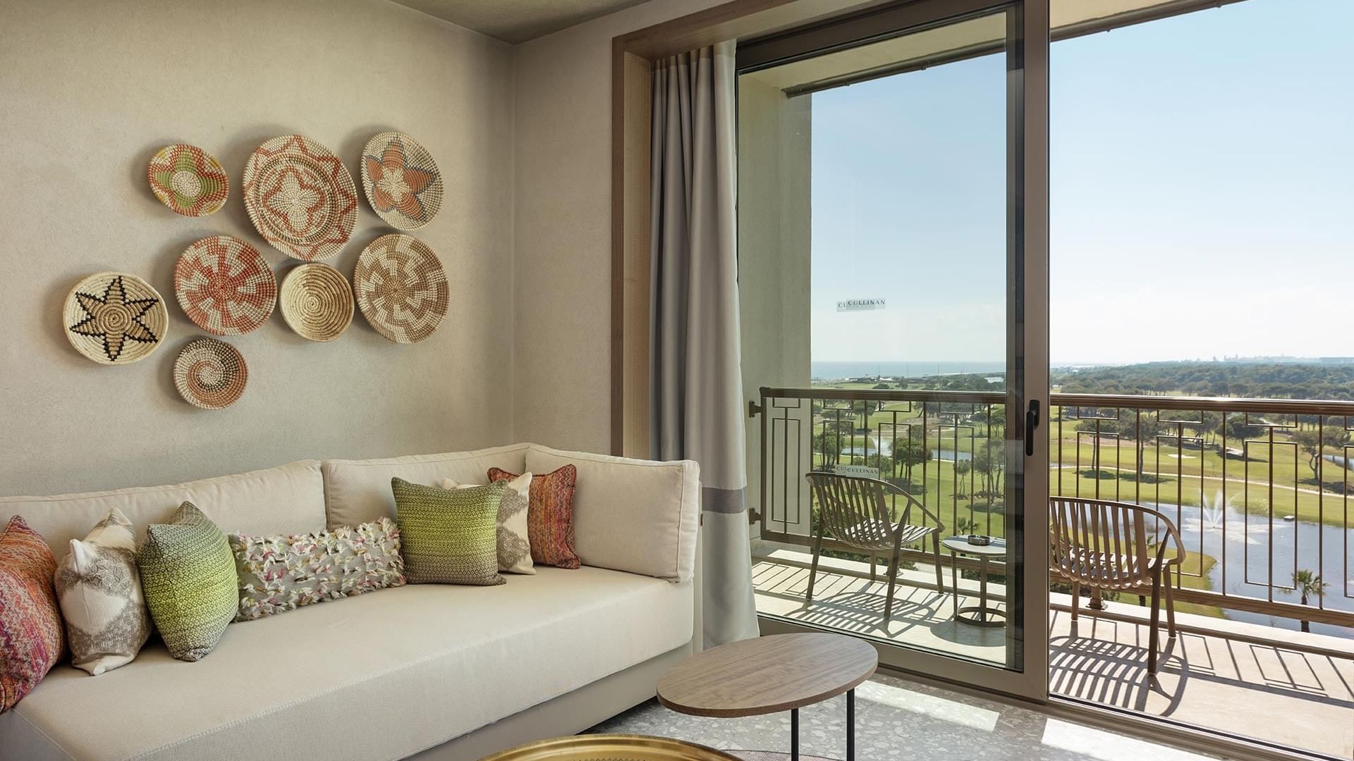 Lounge area with wall decors, sofa & balcony in Superior Room Sea View at Cullinan Belek