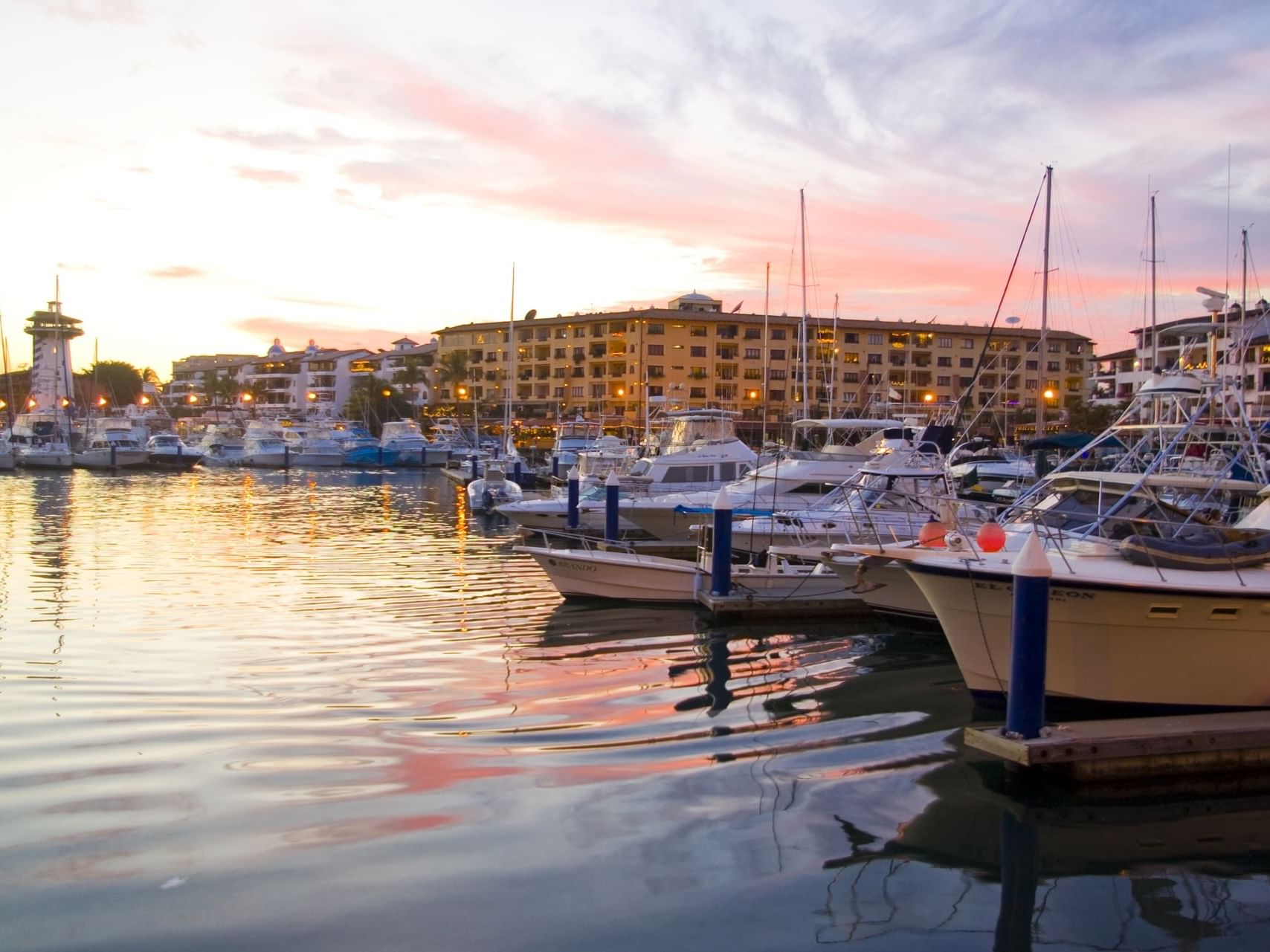 Sunset over Marina Vallarta with boats docked near Plaza Pelicanos Grand Beach Resort