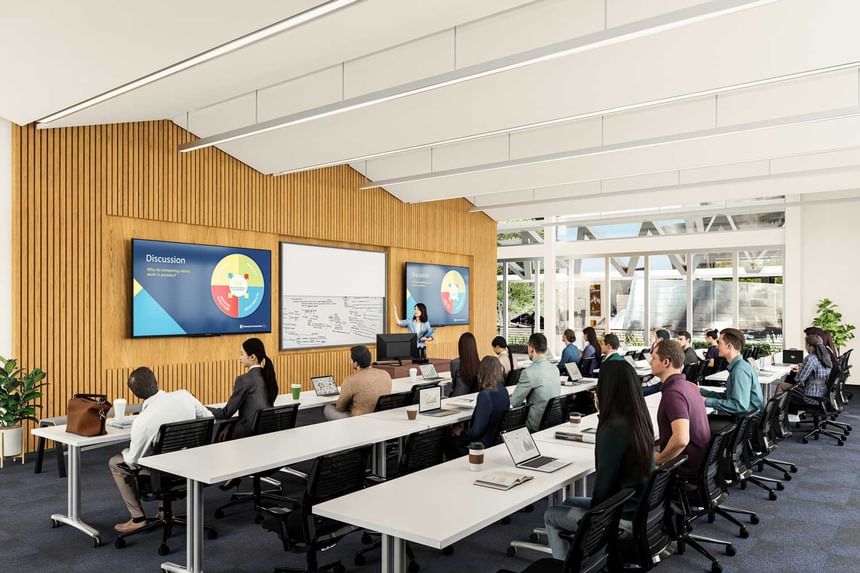 People attending a presentation in a modern conference room at Aramark Ross.