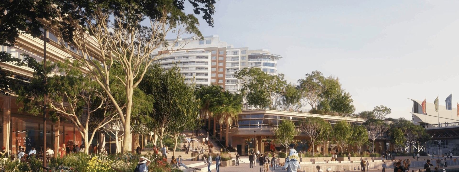 Artist's impression of the Harbourside waterfront promenade in the sun, with gardens, trees, timber seating, bikes and people walking beside the harbour.