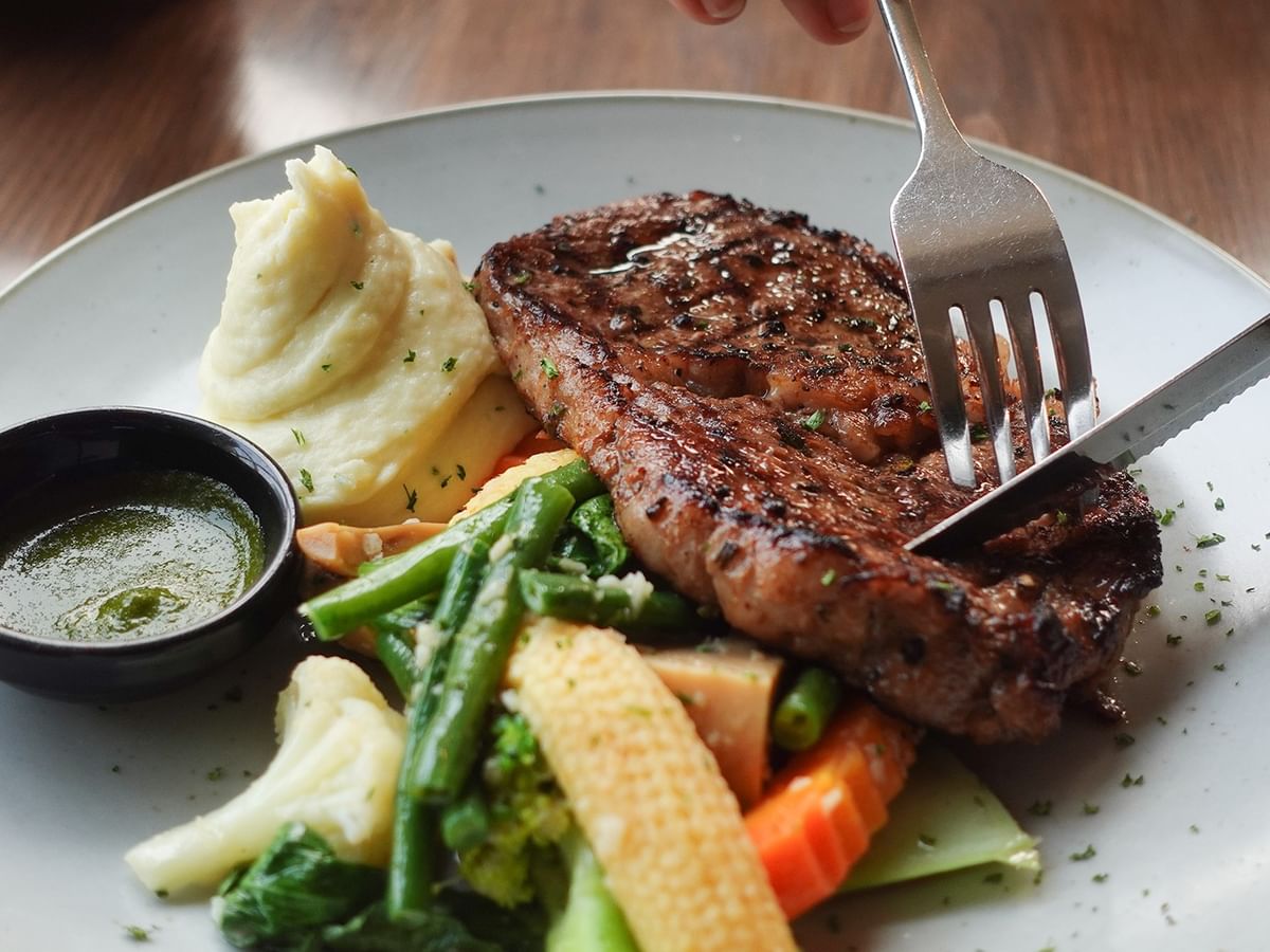 Grilled steak with mashed potatoes and seasonal vegetables at ATLAS steak + fish, Coast Langley City Hotel & Convention Centre