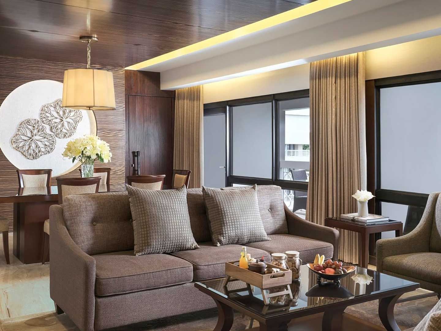 The living area in the Ambarrukmo Suite with a couch and a coffee table in Royal Ambarrukmo Yogyyakarta