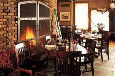 Breakfast set at a table beside a fireplace