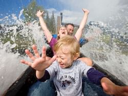 A family having fun on a water slide in Calaway Park near Acclaim Hotel Calgary