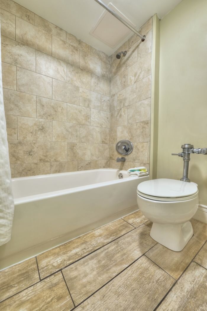A bathroom with a bathtub and toilet