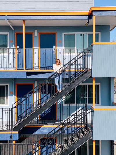 Portrait of a lady posing on stairs  on a sunny day at Becks Motor Lodge