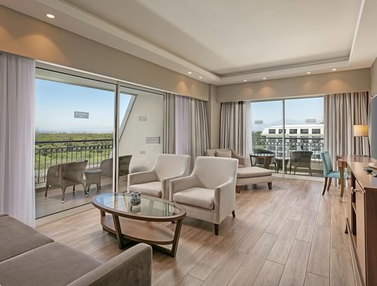 Major Suite's Living Room with TV and wooden floors at Titanic Deluxe Golf Belek