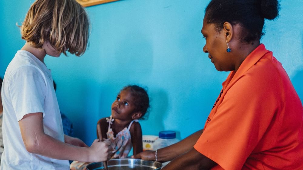Woman and children in a cooking activity at Funtastik Kids Club at Warwick Le Lagon Efate.