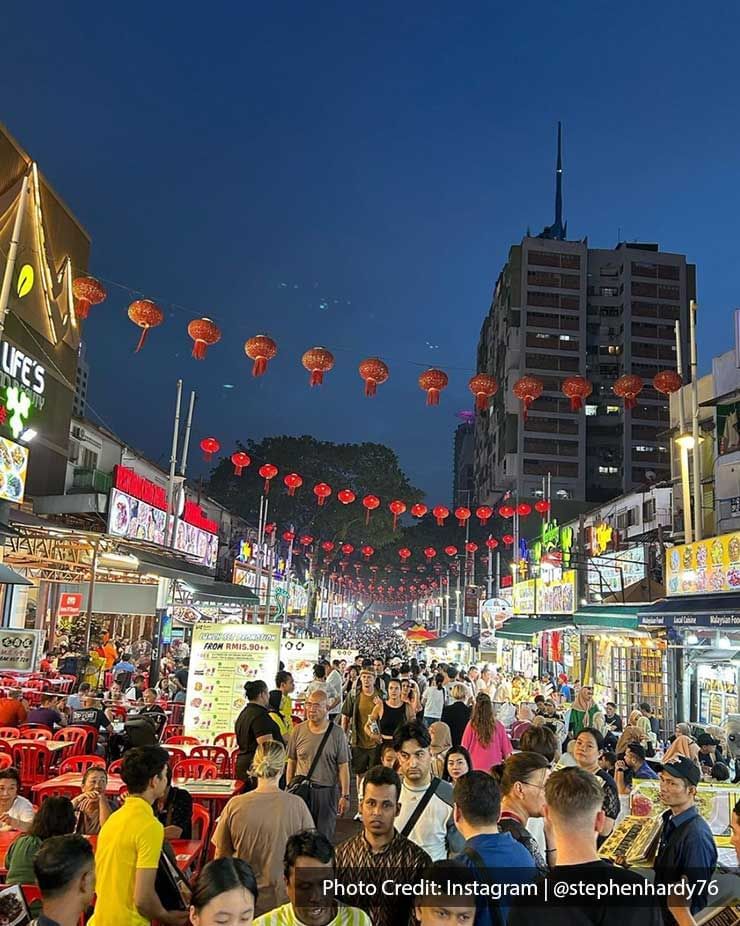 People crowded in the streets at night near Imperial Lexis Kuala Lumpur, enjoying Jalan Alor best food