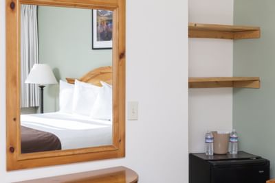 Mirror on wall next to shelves in King Room at Alpenhof Lodge