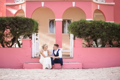 A wedded couple sitting on concrete stairs at Southern Palms