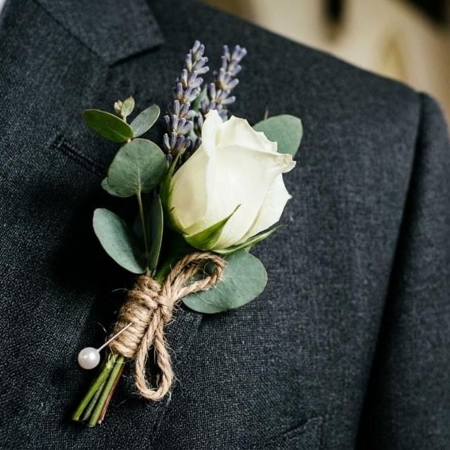 Person wearing buttonhole featuring our article on 