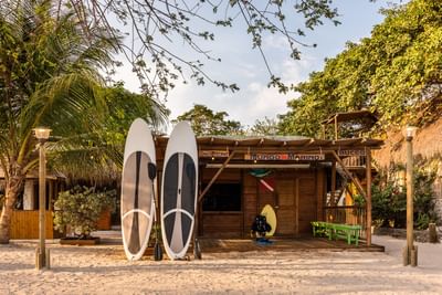 Two surfing boards near the wooden cottage at Hotel Isla Del Encanto