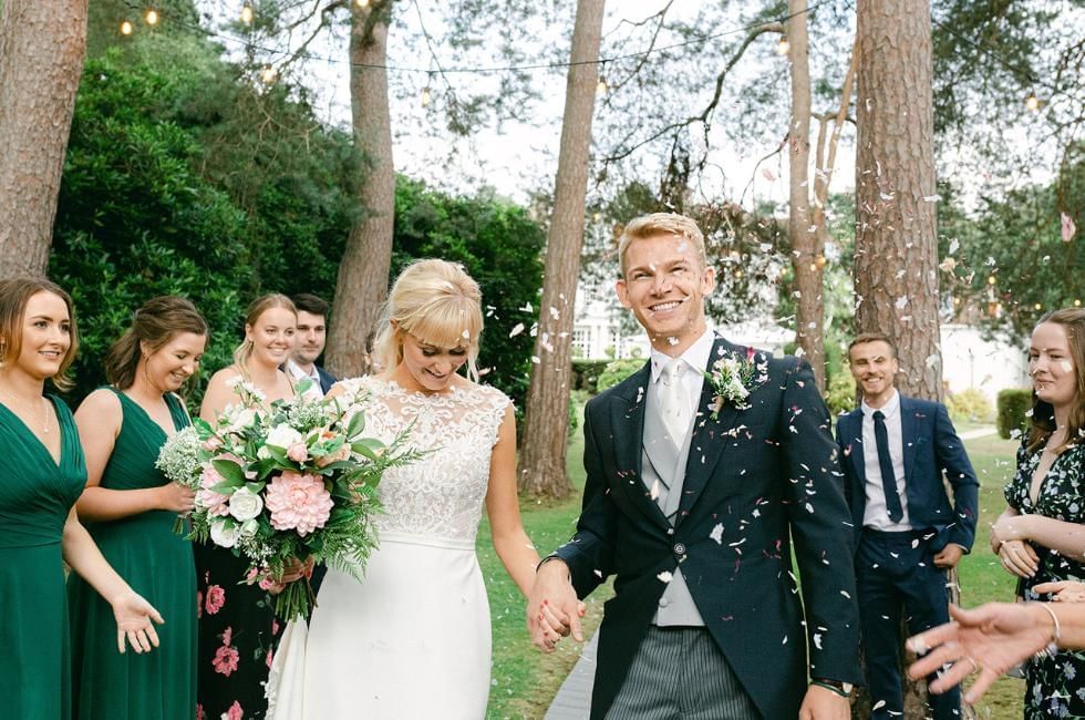 couple getting confetti thrown at them at gorse hill in surrey
