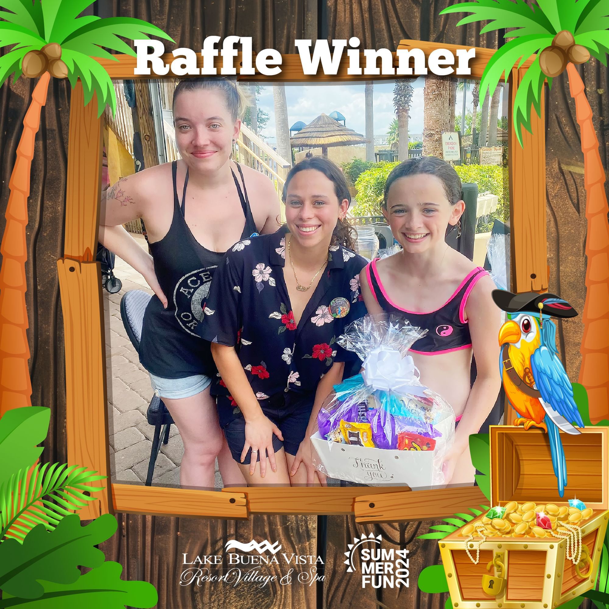 Three people posing with a gift basket at Lake Buena Vista Resort Village & Spa