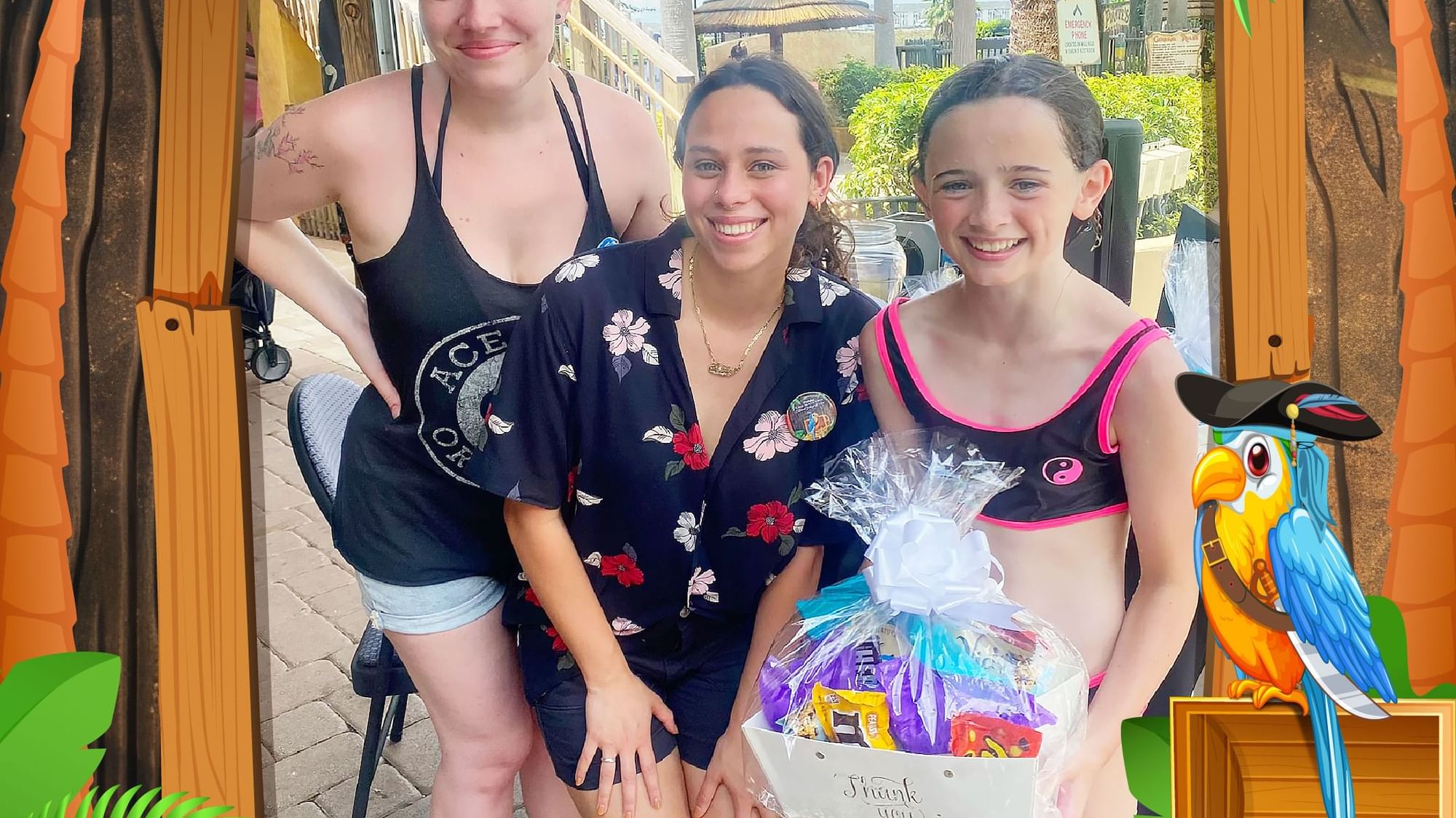 Three people posing with a gift basket at Lake Buena Vista Resort Village & Spa