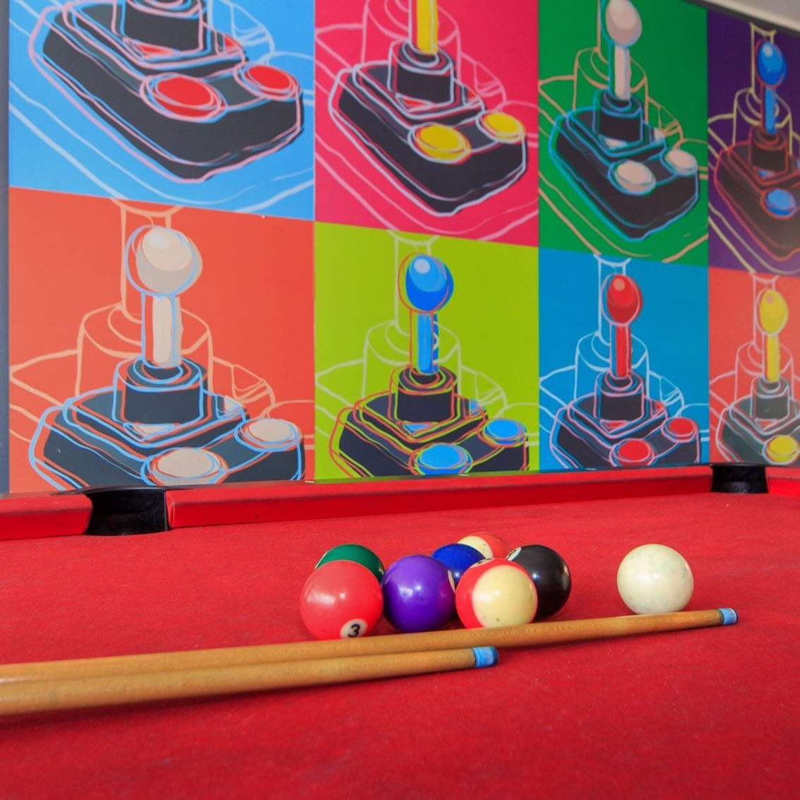 Closeup of the Pool table and cue sticks at Pop Art Tocanicipa