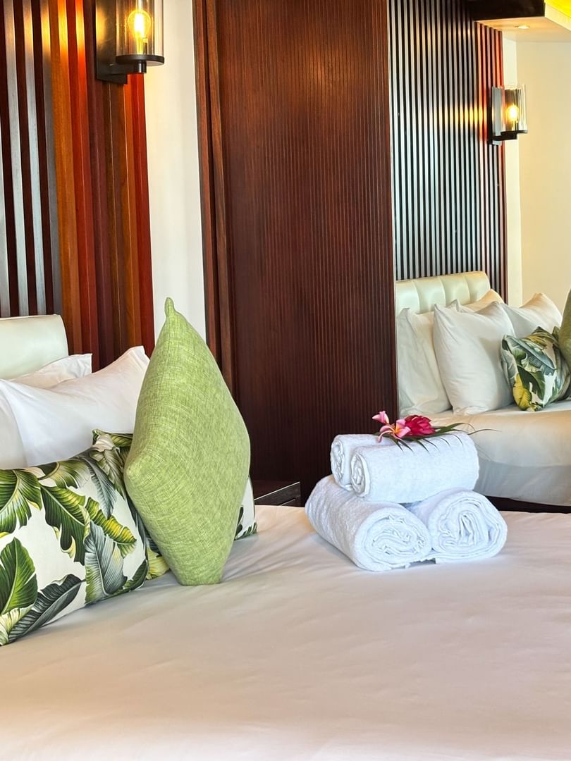 Clean Warwick Suite bedroom with towels and pillows at Warwick Fiji Resort and Spa, Korolevu.