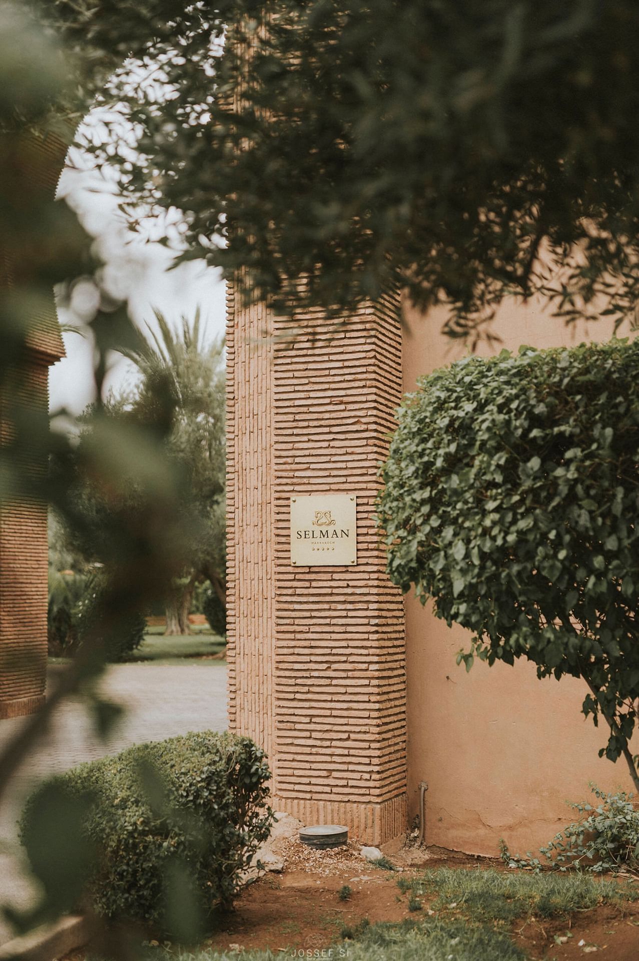 Selman Marrakech hotel logo on a wall in the garden