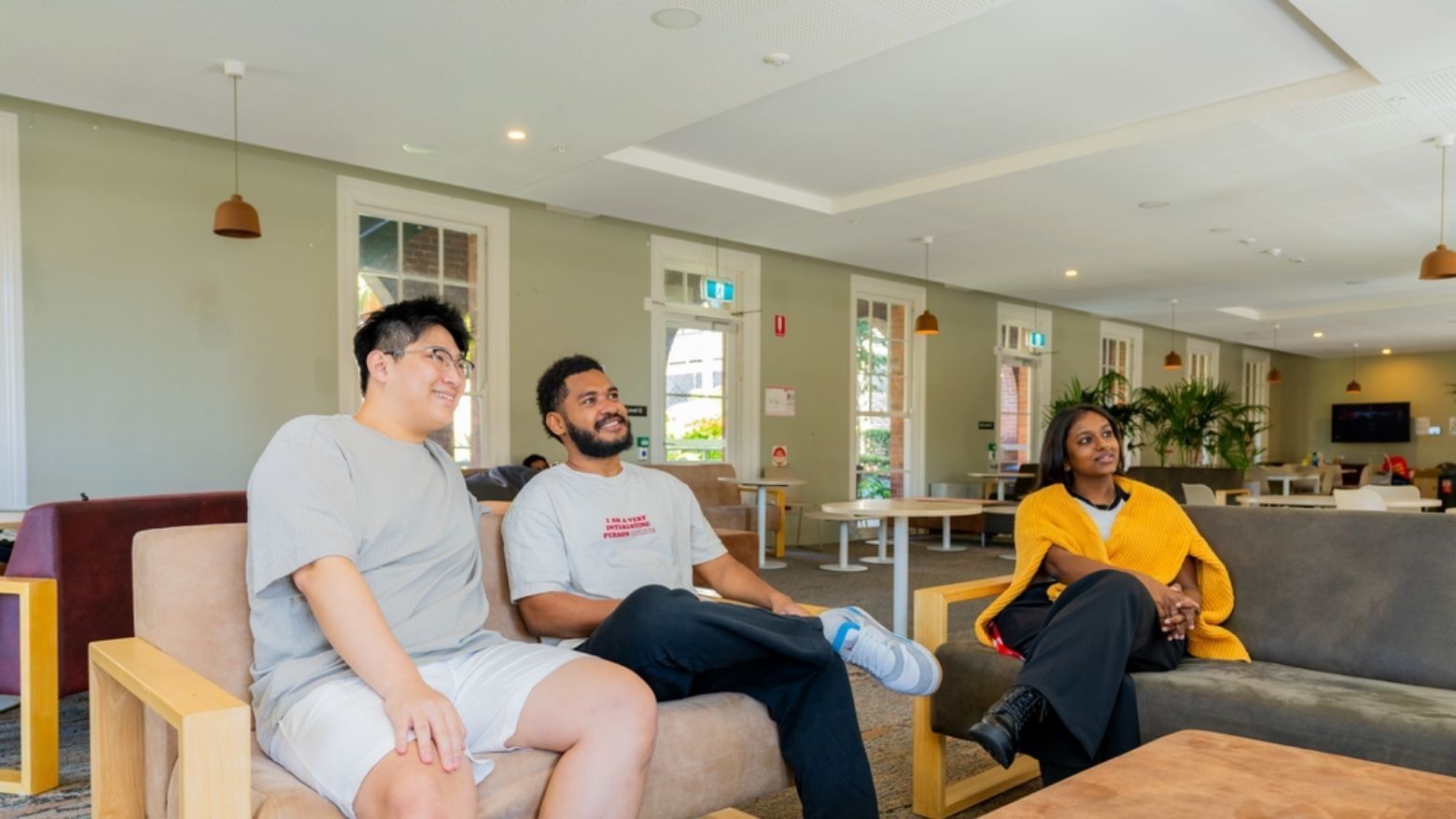 Students relaxing on couches in lounge area at UniLodge Herston.