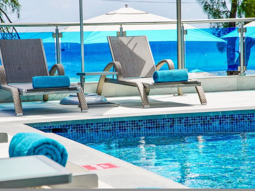 Exterior of the outdoor pool with lounges at The Abidah Hotel