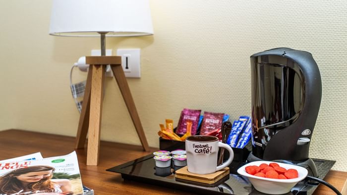 Coffee maker & some snacks on a table at Hotel Pic Epeiche