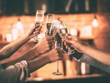 A group of people toasting champagne near Kinzie Hotel