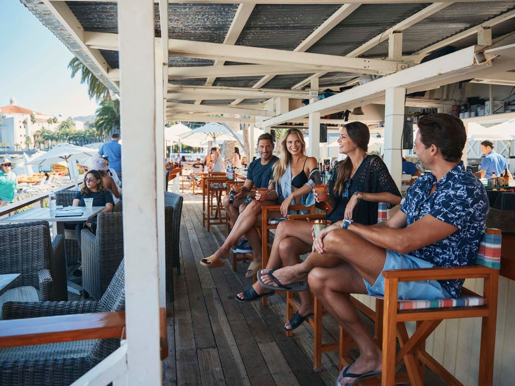 Group of people enjoying their drinks in Descanso Beach Club at Hotel Atwater