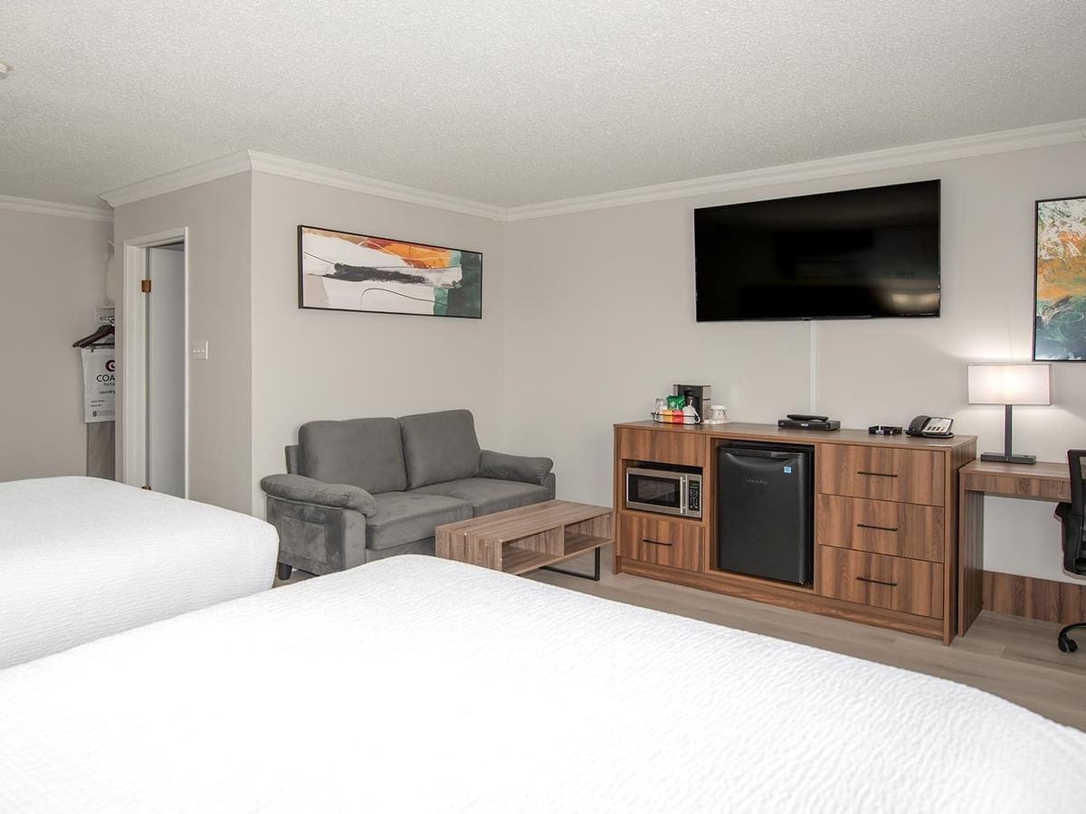 Two queen beds, couch, desk, and TV.