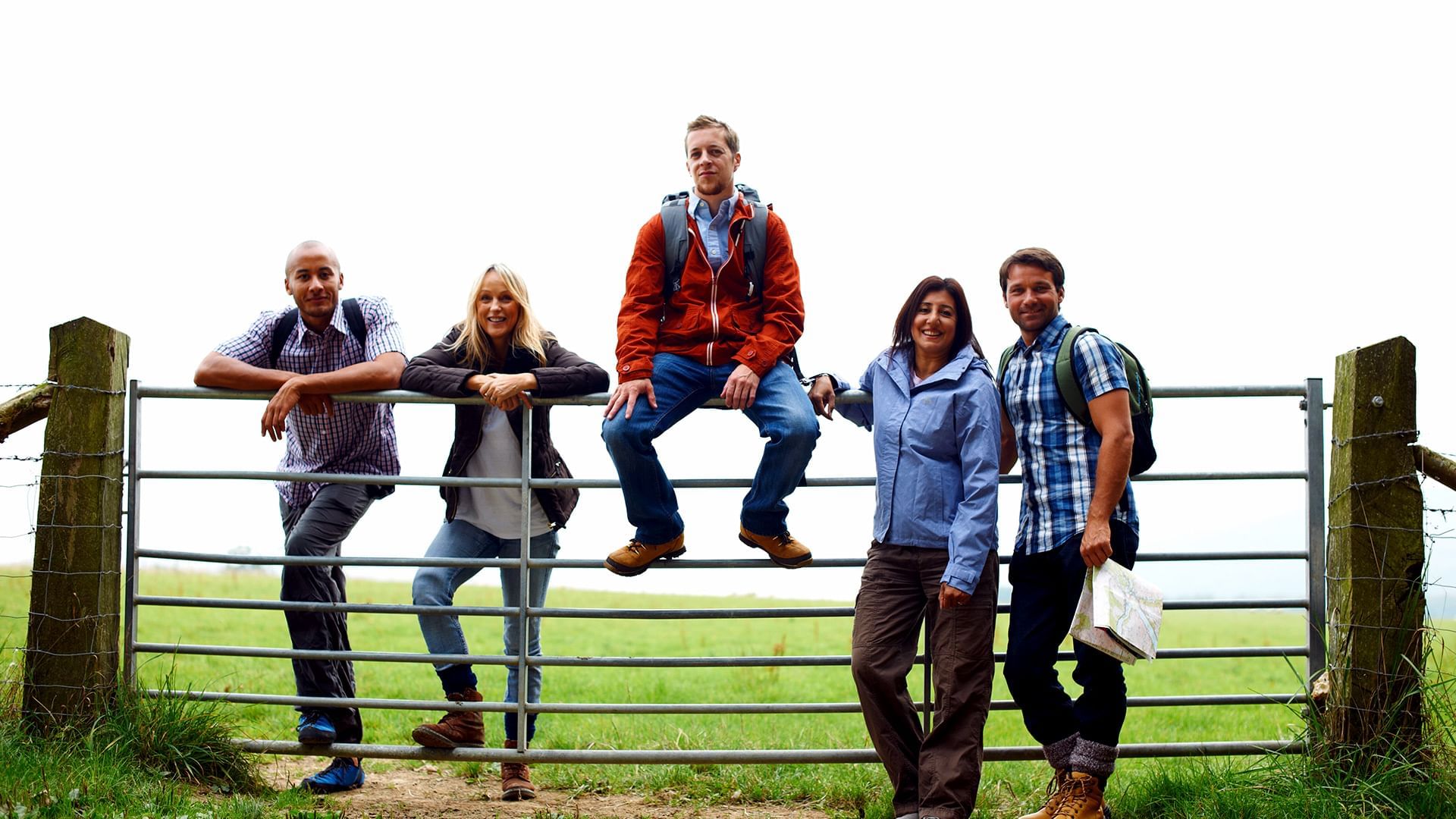 friends posing at a farm gate