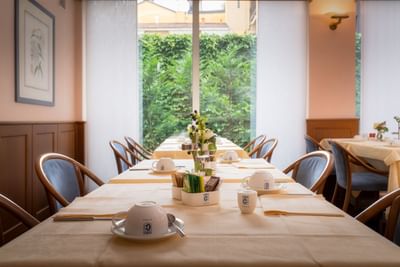 Breakfast Room with well-arranged dining table setup at Hotel Crivi's in Milan
