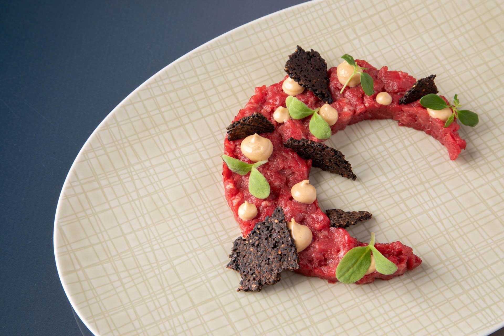Close-up of a steak tartare plate served at The Glam Hotel
