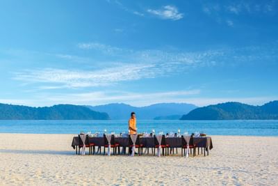 Dining table set-up by the beach at Pelangi Beach Resort & Spa