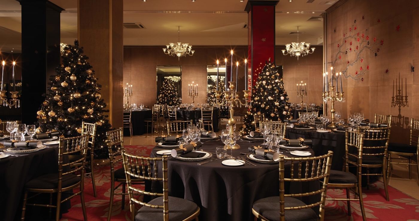 Luxurious Christmas dining tables with elegant gold and black decorations at The May Fair Hotel