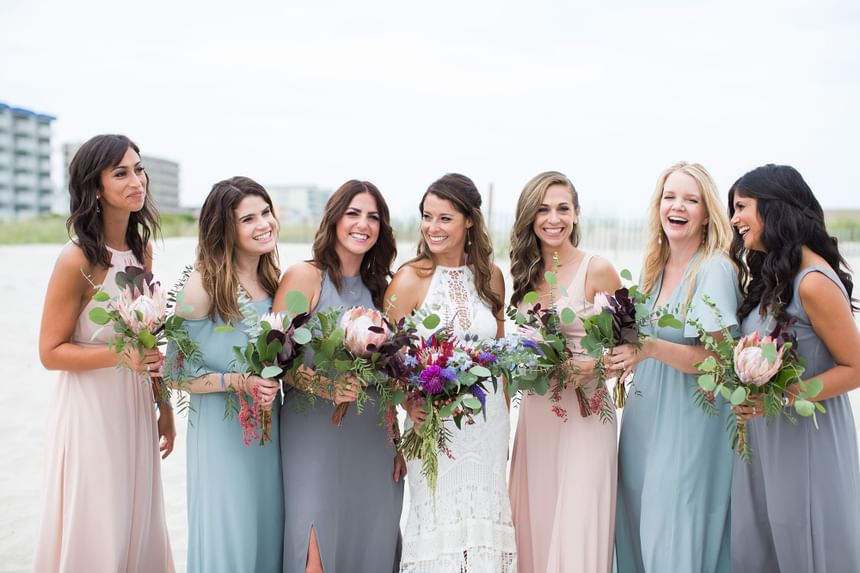 Bride and bridesmaids posing for a picture at our Diamond Beach wedding venue