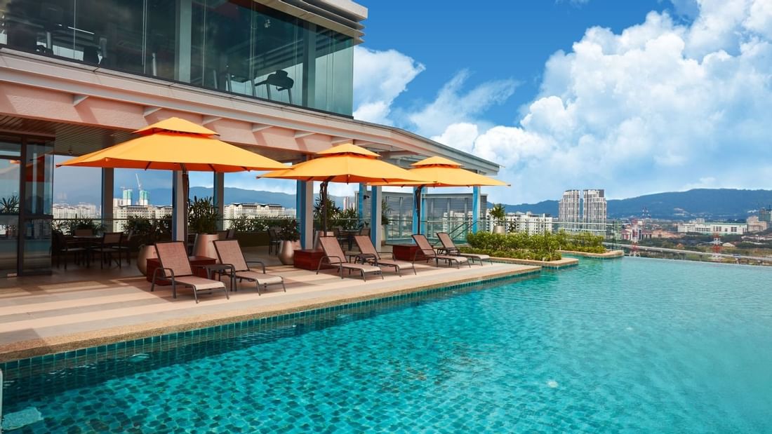 Infinity swimming pool at Sunway Velocity Hotel with deck chairs