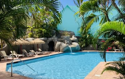 Pool & rock waterfall at Emerald Beach Resort, relaxing oceanfront moments at a St. Thomas resort with pool facing the ocean