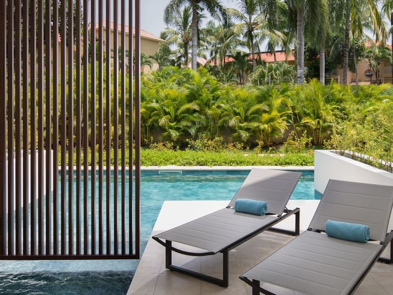 Sunbeds & pool in Aqua Swim-Up Garden View at Live Aqua Resorts