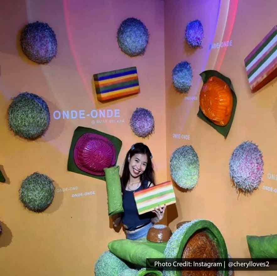 Lady took a picture with various kuih muih at Wonderfood Museum Penang - Lexis Suites Penang