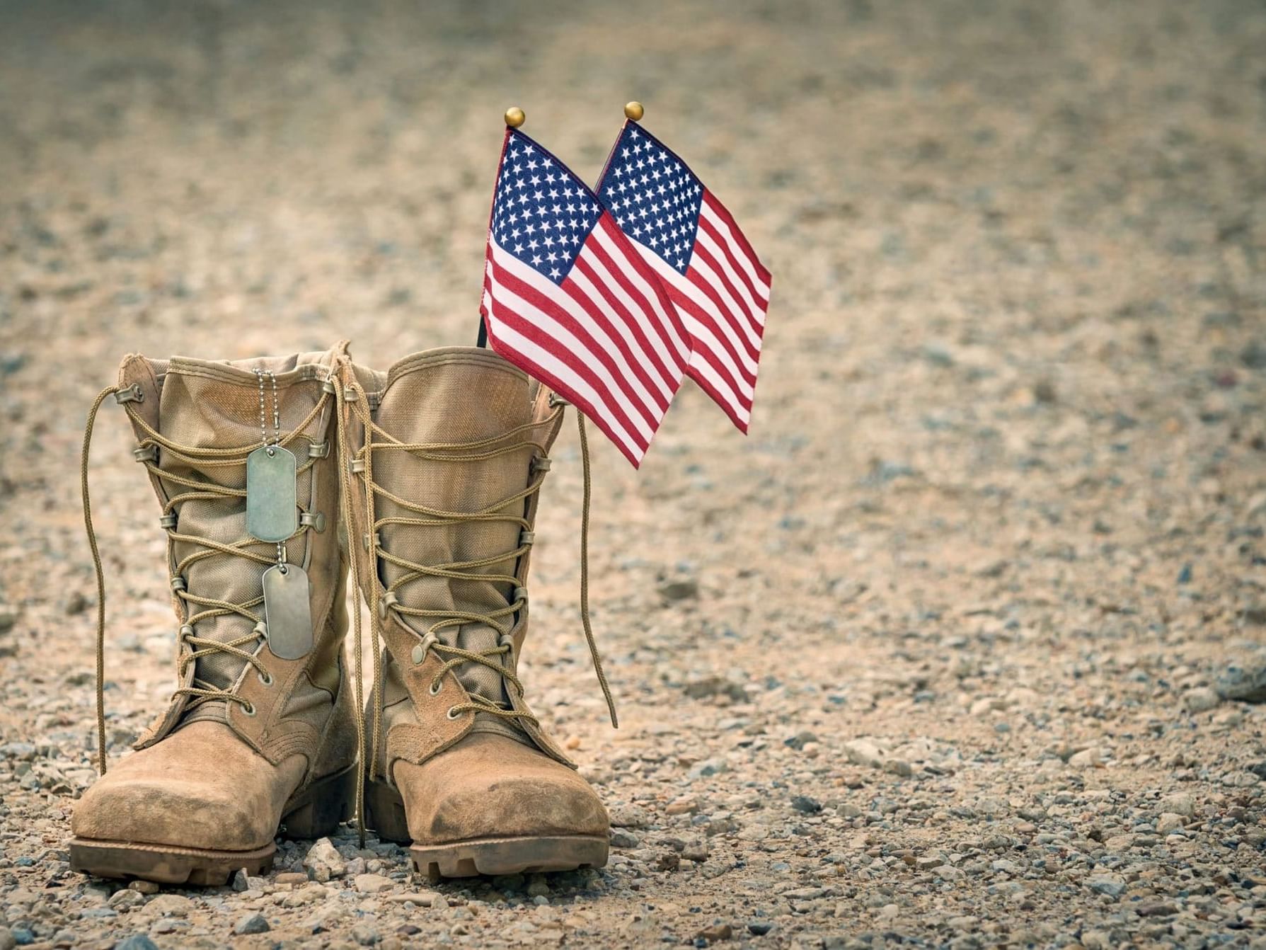 American flags in military shoes on the sandy surface at Horton Grand Hotel
