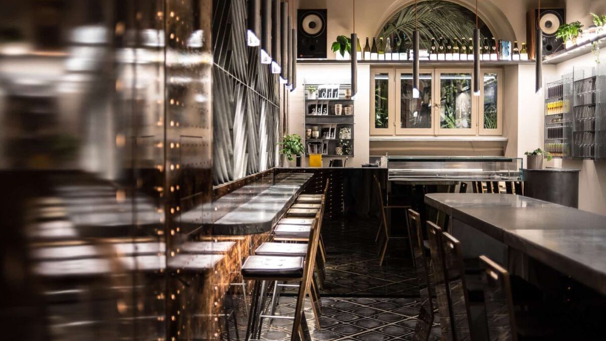 Interior view with bar counter and dining table in Bar Sota near Rome Luxury Suites