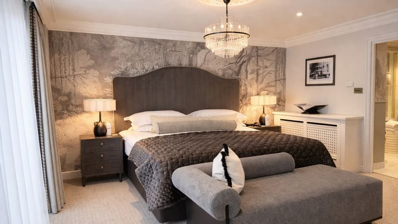 Elegant bedroom with large bed, chandelier.