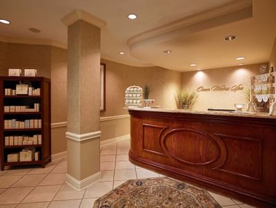 spa reception desk with products on shelf