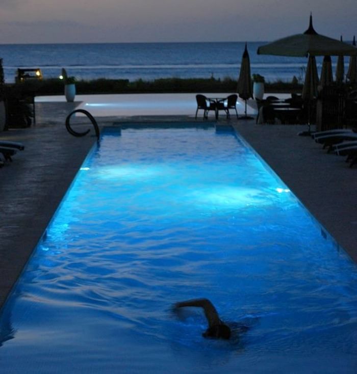 Guy swimming in the pool at The Somerset On Grace Bay