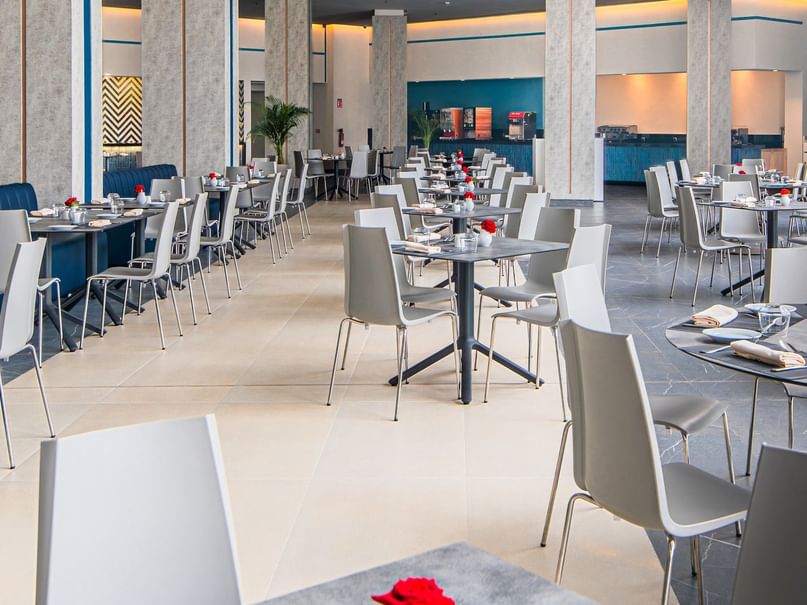 Mediterranean restaurant interior with tables and chairs at Pickalbatros Palais Des Roses Agadir in Agadir.