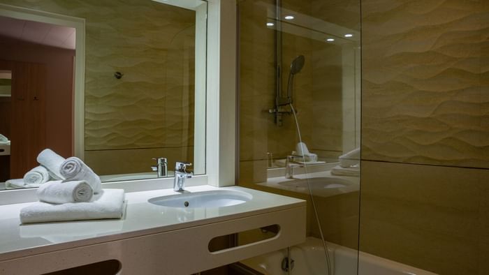Bathroom vanity in bedrooms at Hotel Les Trois Roses