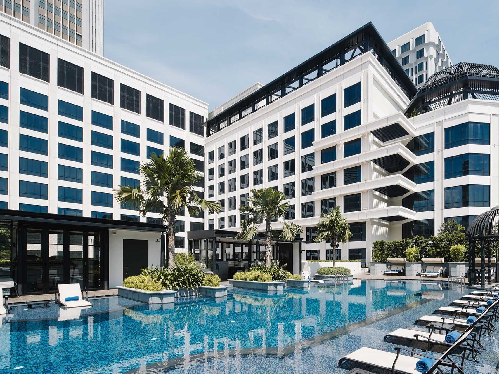 Grand Park City Hall with poolside loungers and modern architecture