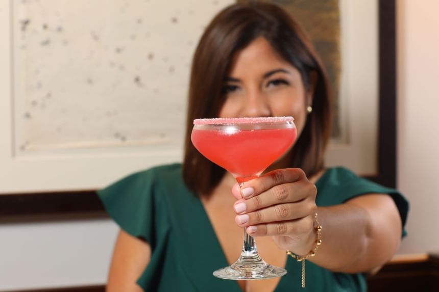 woman showing off cocktail drink