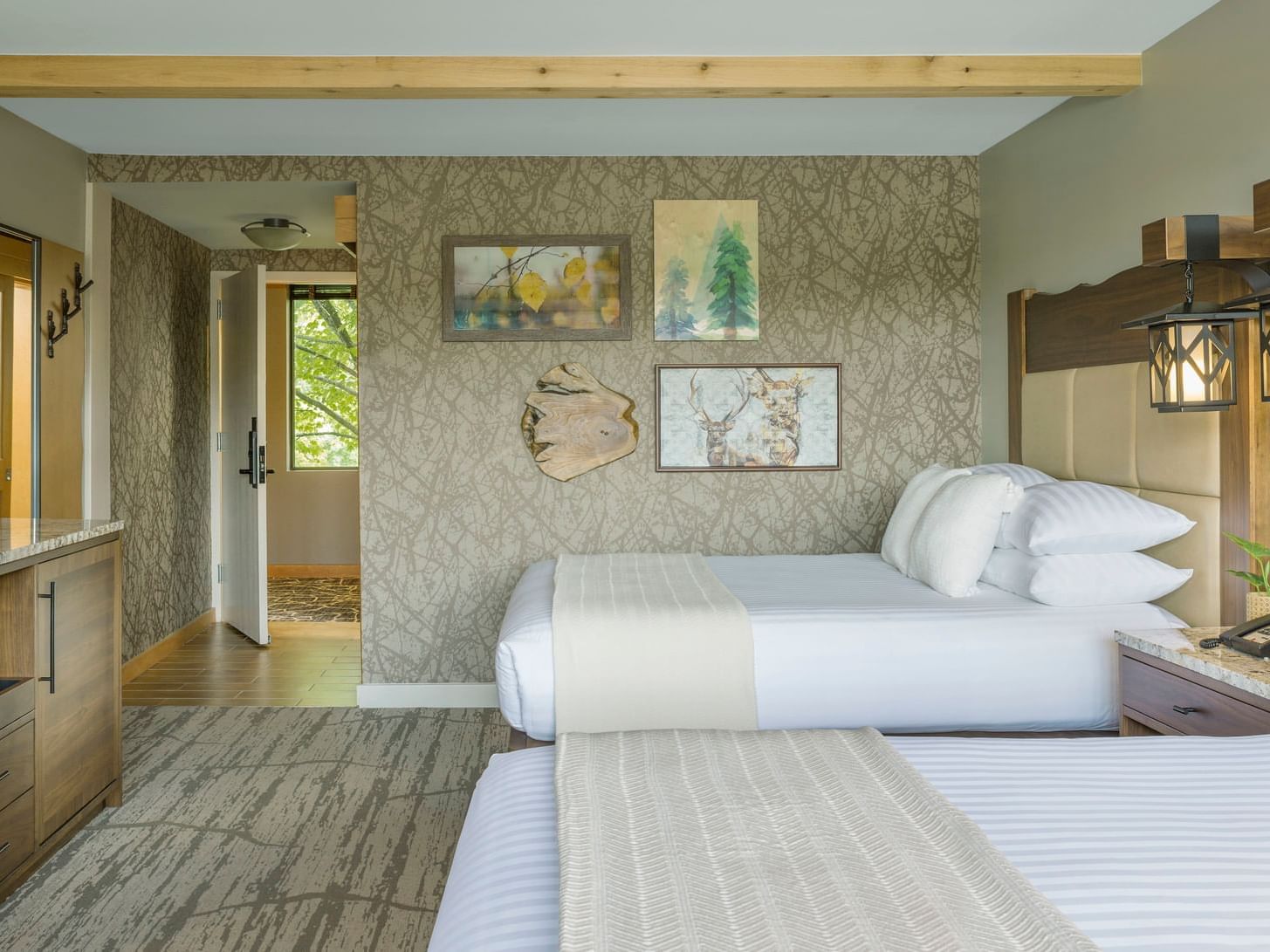 Double Queen Bedroom with beds & paintings at High Peaks Resort